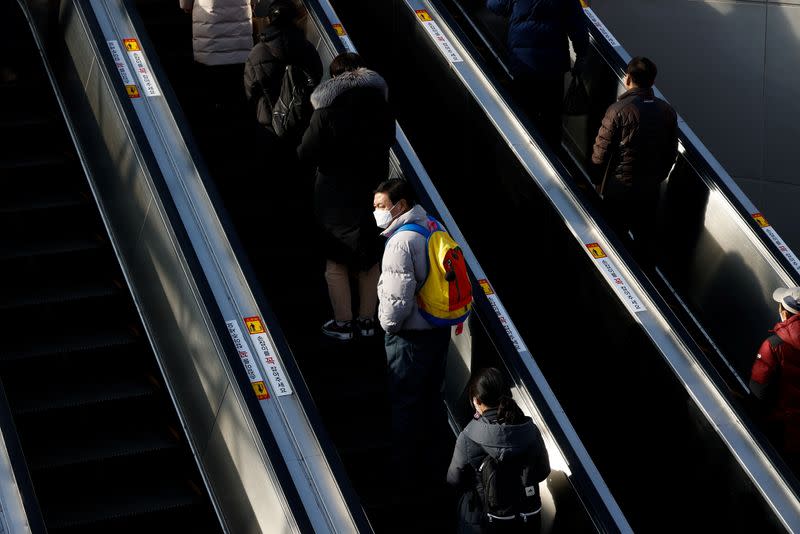 People ride on escalators amid the coronavirus disease (COVID-19) outbreak at a railway station in Seoul