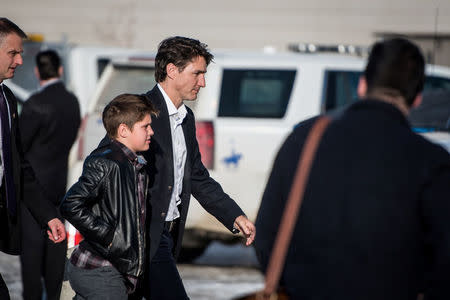 Canadian Prime Minister Justin Trudeau arrives with his son Xavier at the Elgar Petersen Arena to attend a vigil for members of the Humboldt Broncos in Humboldt, Saskatchewan, Canada April 8, 2018. REUTERS/Matt Smith