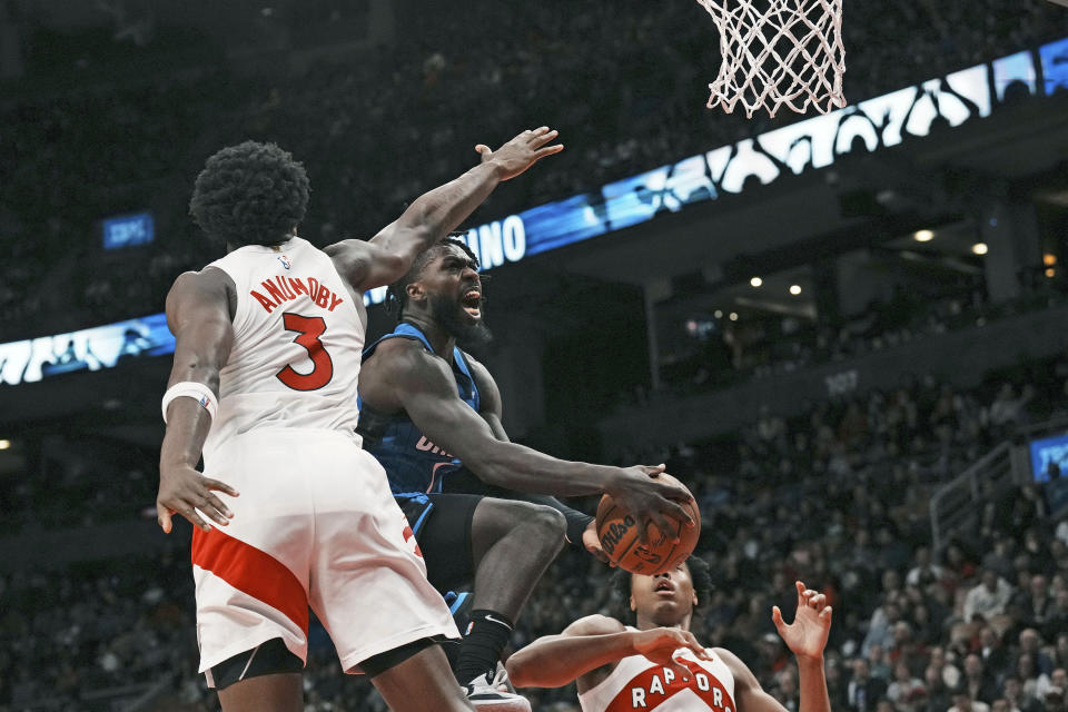 Orlando Magic guard Kevon Harris goes to the basket on Toronto Raptors O.G. Anunoby (3) during the second half of an NBA basketball game, Saturday, Dec. 3, 2022 in Toronto. (Chris Young/The Canadian Press via AP)