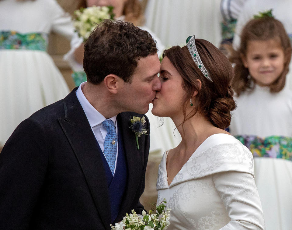 Princess Eugenie and Jack Brooksbank kiss on the steps of St George’s Chapel in Windsor Castle after their wedding, Britain October 12, 2018. Steve Parsons/Pool via REUTERS