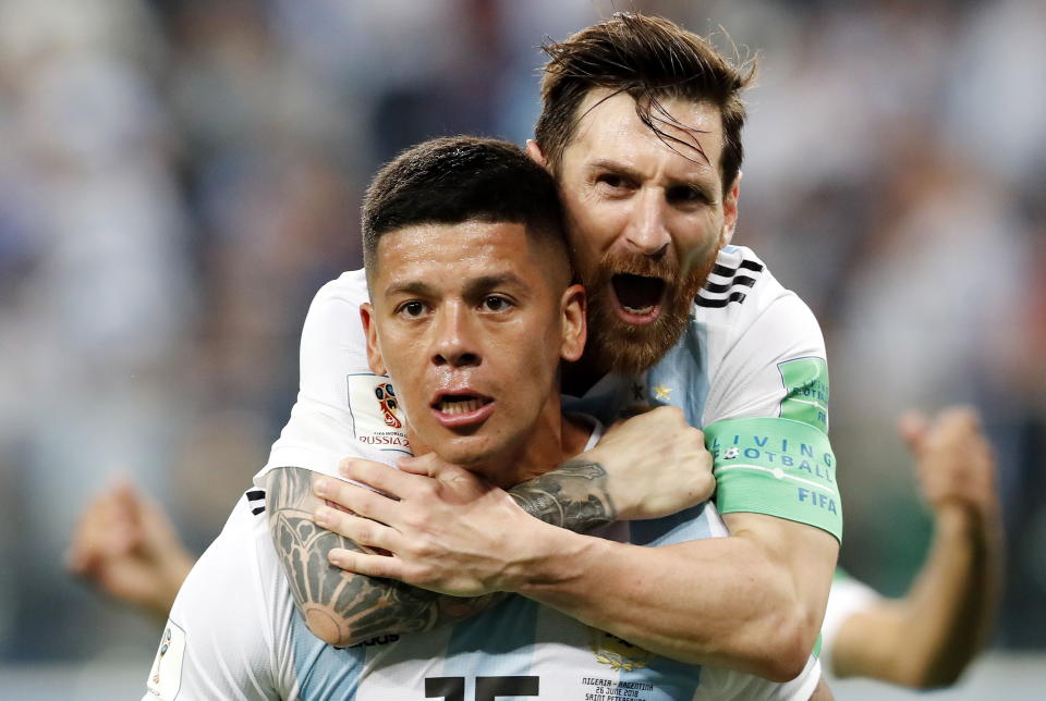 Surprise hero: Marcos Rojo celebrates with team-mate Lionel Messi as Argentina sneak through