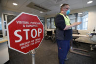 Bradley Mattes, associate nurse leader at Central Maine Medical Center, questions patients at the emergency entrance to the hospital, Friday, March 13, 2020, in Lewiston, Maine. "I refer to myself as the Walmart greeter of nurses," said Mattes, who questions patients to determine if their symptoms indicate the need for testing for the coronavirus or other medical attention. (AP Photo/Robert F. Bukaty)