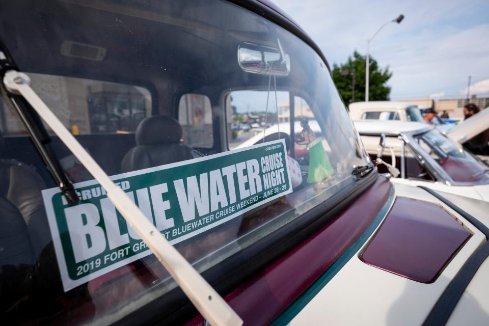 A sticker for Blue Water Cruise Night  is mounted in the window of a classic car on cruise night, Friday, June 28, 2019 in Fort Gratiot.