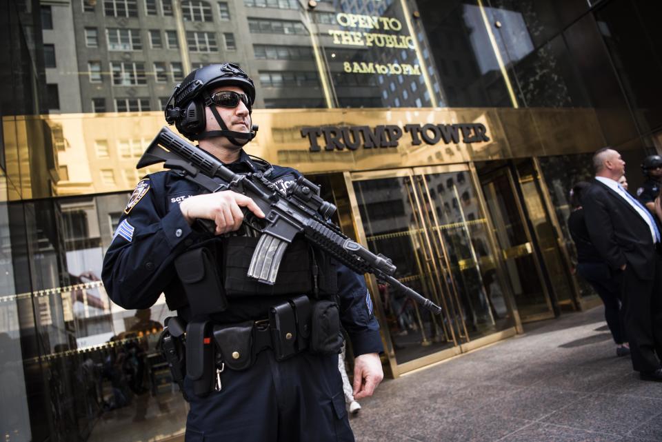 An armed police officer stands guard at the entrance of Trump Tower on April 13. Extra security measures at the building have been a hassle for residents.&nbsp; (Photo: Damon Dahlen/HuffPost)