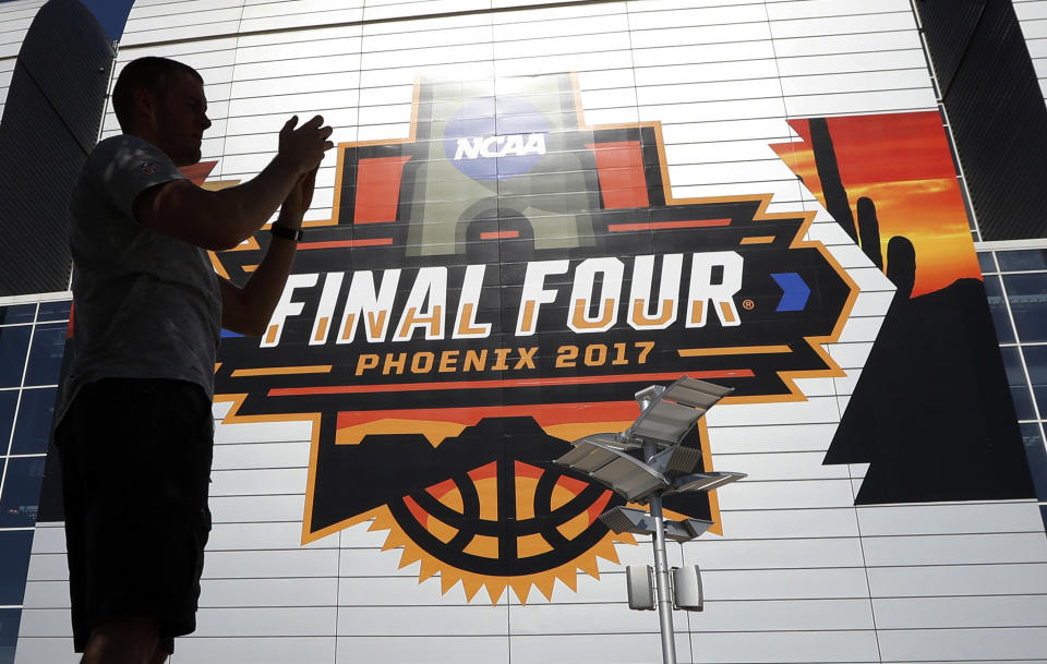 A fan takes a pictures outside of University of Phoenix Stadium before the finals of the Final Four NCAA college basketball tournament between Gonzaga and North Carolina, Monday, April 3, 2017, in Glendale, Ariz. (AP Photo/Charlie Neibergall)