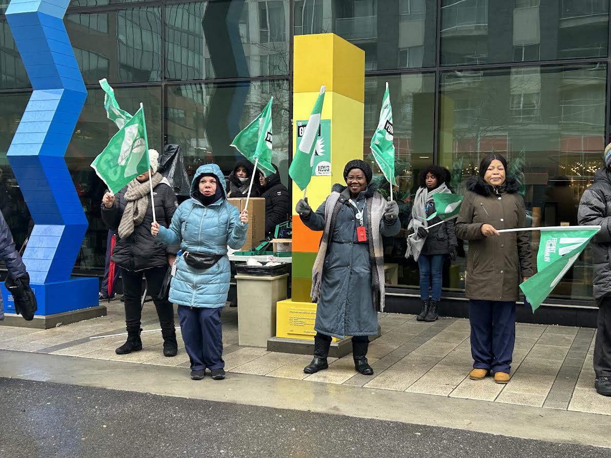 Despite the rain on Sunday, protesters waved the green and white flags of the common front in front of the Centre hospitalier de l'Université de Montréal. (Sara Eldabaa/CBC - image credit)