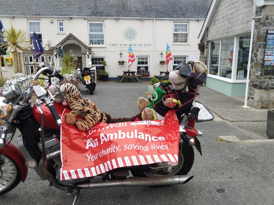 Mary Dean's motorbike with a Cornwall Air Ambulance banner attached to the side