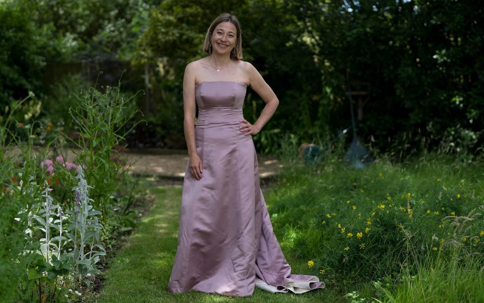 Hannah tries on her wedding dress (pink side out), 20 years after her wedding