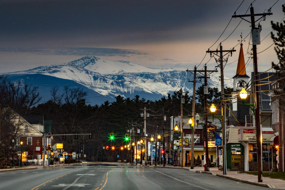 Mt. Washington looms in the distance over scenic North Conway, N.H., where most small shops and churches remain closed during the coronavirus pandemic, Sunday, April 26, 2020. (AP Photo/Robert F. Bukaty)