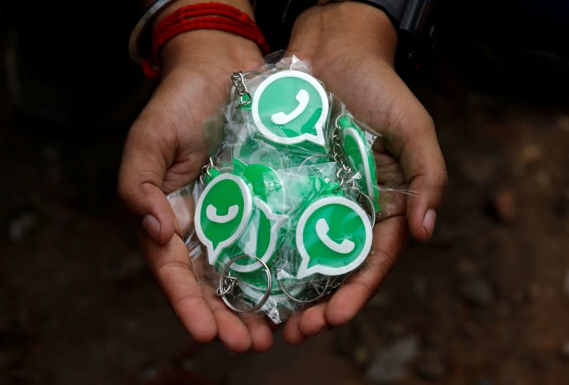 FILE PHOTO: A WhatsApp-Reliance Jio representative displays keychains with the logo of WhatsApp for distribution during a drive by the two companies to educate users, on the outskirts of Kolkata