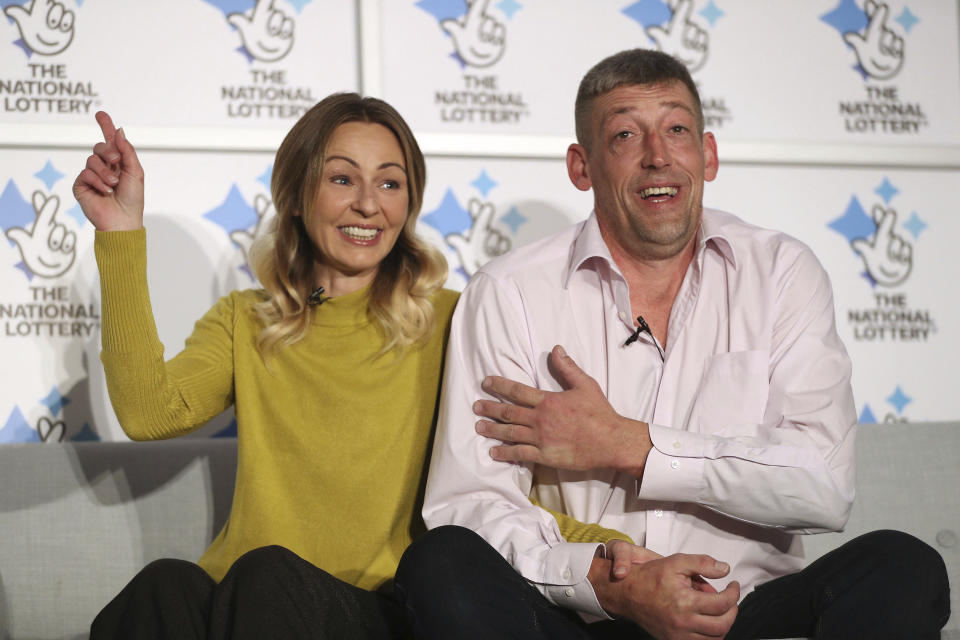 Self-employed builder Steve Thomson and his wife Lenka celebrate their 105 million pounds EuroMillions win (US dollars 135 million) as they face the media at Walberton, England, Tuesday Nov. 26, 2019.  Steve and Lenka, who is originally from Slovakia, have three school aged children and have won the 9th largest jackpot ever in the UK. (Andrew Matthews/PA via AP)