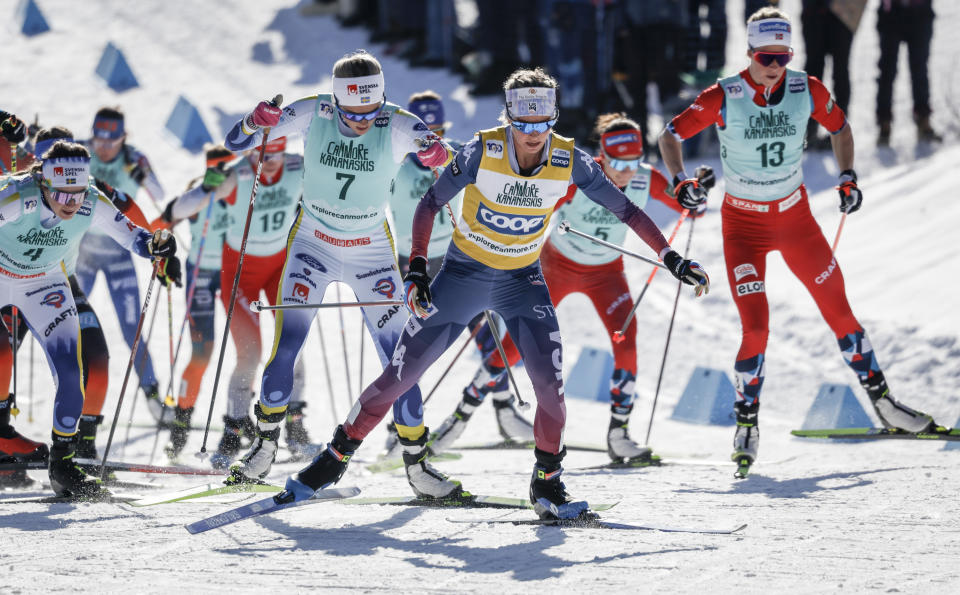 Jessie Diggins, center, of the United States, leads the pack as she skis during the women's 15km Mass Start freestyle World Cup cross country skiing event in Canmore, Alberta, Friday, Feb. 9, 2024. (Jeff McIntosh/The Canadian Press via AP)