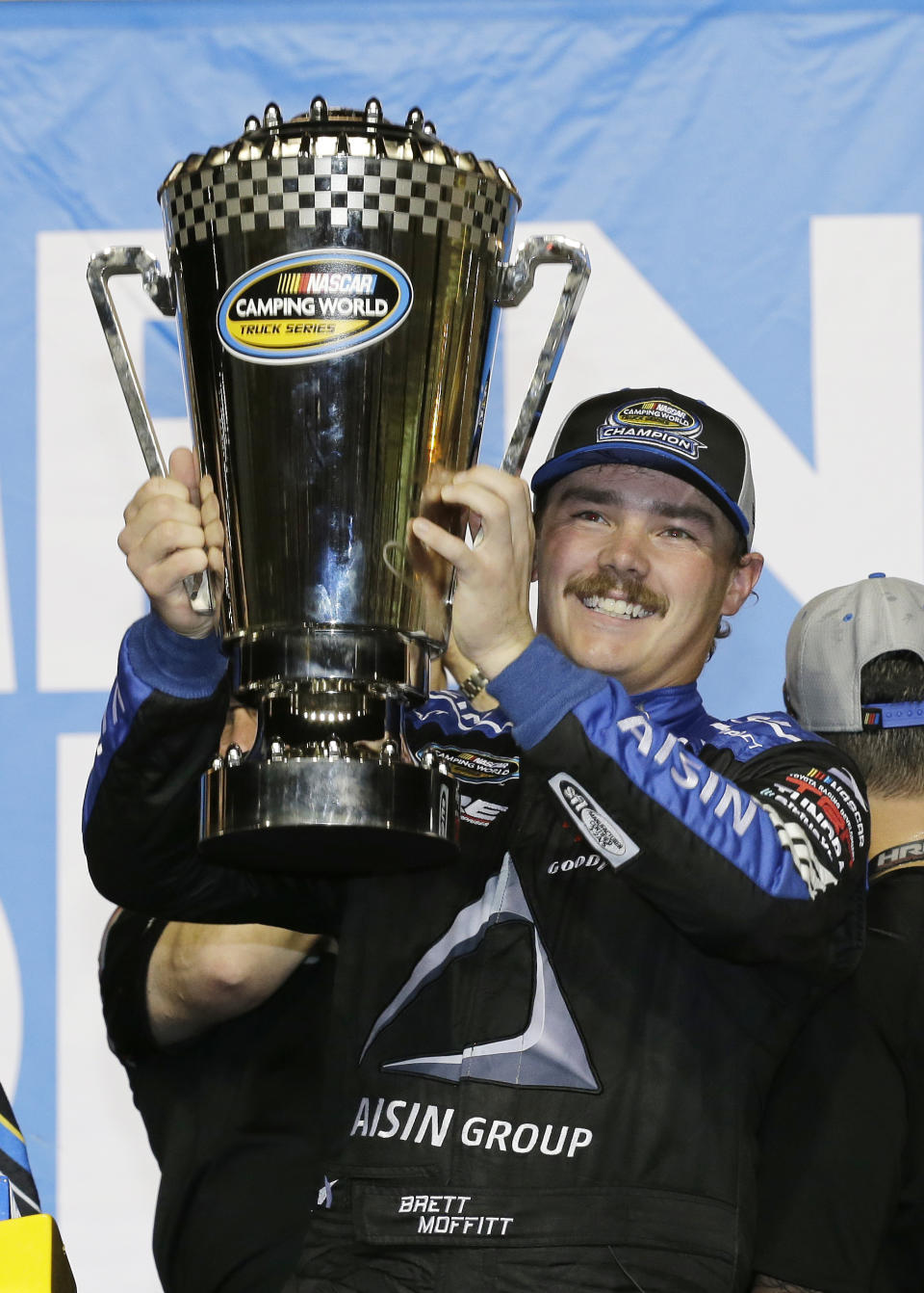 Brett Moffitt holds up his trophy in Victory Lane after winning the NASCAR Truck Series auto racing season championship at Homestead-Miami Speedway in Homestead, Fla., Friday, Nov. 16, 2018. (AP Photo/Terry Renna)