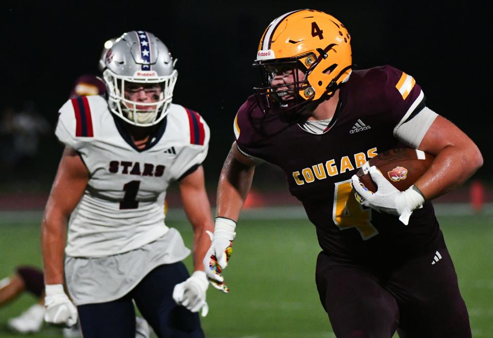 Bloomington North’s Aidan Steinfeldt (4) runs after a catch as BNL's Braden Baker gives chase during their football game at North on Friday, August 26, 2023.