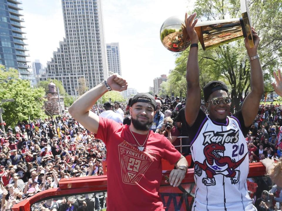 Toronto Raptors guard Fred VanVleet, left, and former guard Kyle Lowry, right, celebrate during the 2019 NBA championship parade in Toronto on Monday, June 17, 2019. Lowry and the rest of the 2019 team will be honoured with street names in the city at a ceremony on Monday. (Frank Gunn/Canadian Press - image credit)