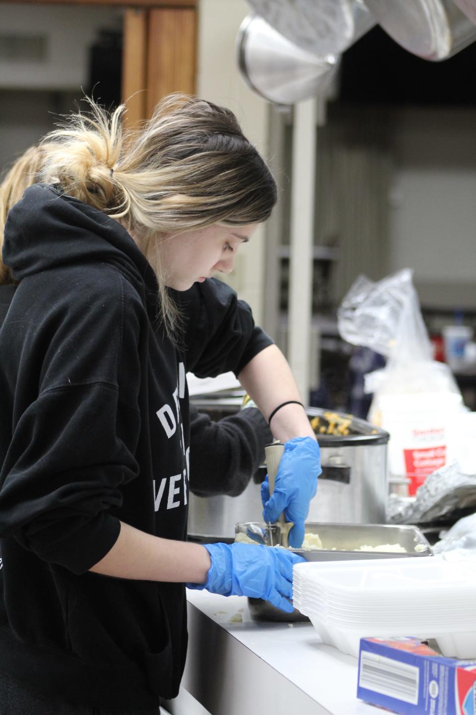 Volunteers inside the Knights of Columbus Hall packaged the dinners for everyone, separating them into hot and cold items, then sent them out the door to the waiting patrons.