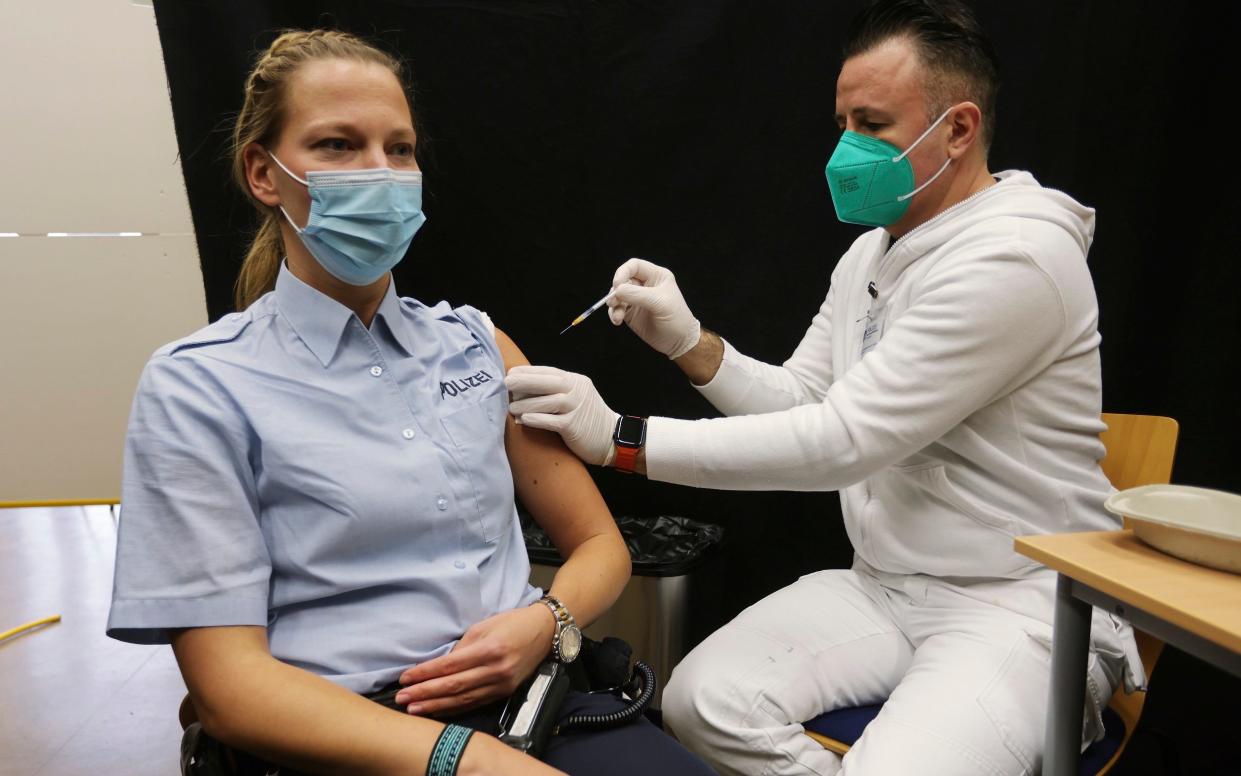 A policewoman gets a booster vaccination in Hilden, Germany, Thursday, Dec 2 - DPA