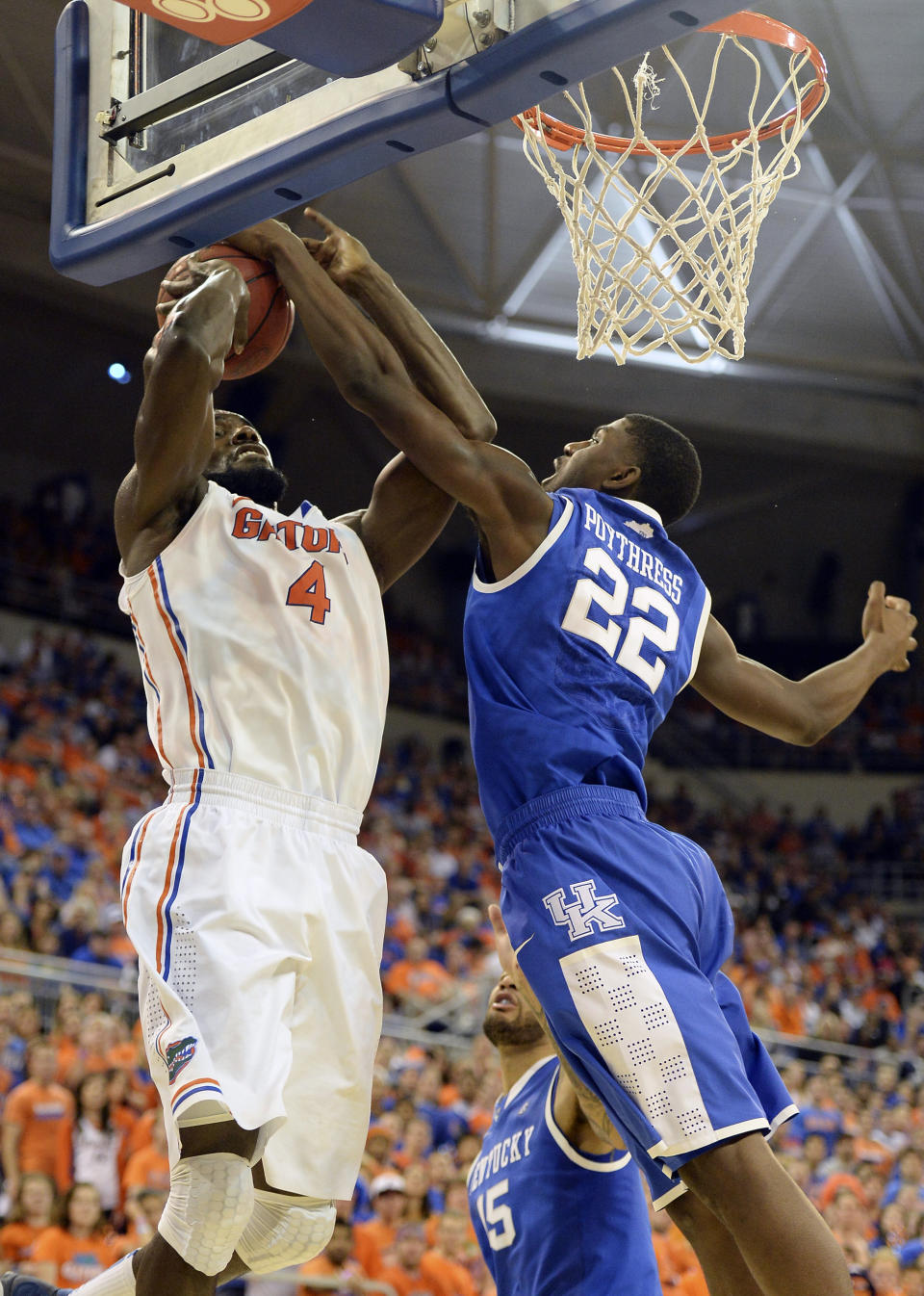 Florida center Patric Young (4) goes to the basket but is blocked by Kentucky forward Alex Poythress (22) during the first half of an NCAA college basketball game Saturday, March 8, 2014 in Gainesville, Fla. (AP Photo/Phil Sandlin)