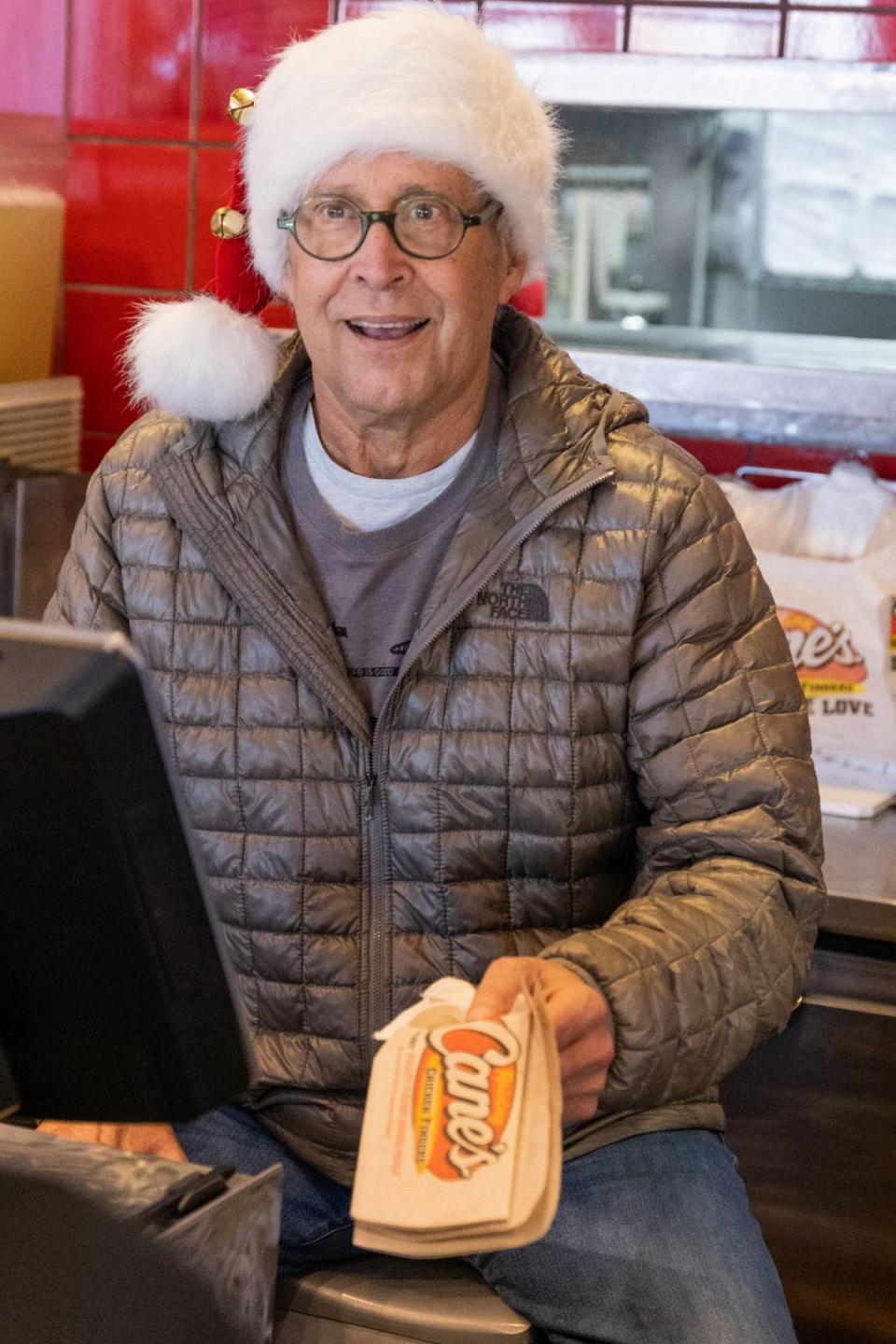 Chevy Chase served customers at Raising Cane’s on Rivers Avenue in North Charleston on Dec. 2, 2021, after an impromptu visit for lunch.