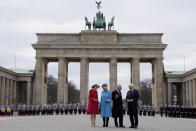 FILE - German President Frank-Walter Steinmeier, right, and his wife Elke Buedenbender, left, welcome Britain's King Charles III and Camilla, the Queen Consort, in front of the Brandenburg Gate in Berlin, Wednesday, March 29, 2023. A year after the death of Queen Elizabeth II triggered questions about the future of the British monarchy, King Charles III’s reign has been marked more by continuity than transformation, by changes in style rather than substance. (AP Photo/Matthias Schrader, File)