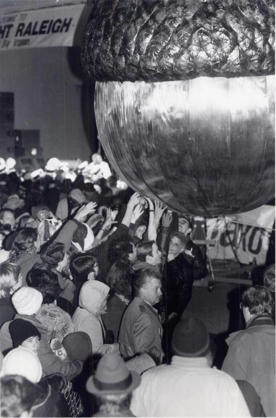 Crowds from Raleigh’s first “First Night” festivities greeted 1992 by touching the acorn for luck. N&O File Photo
