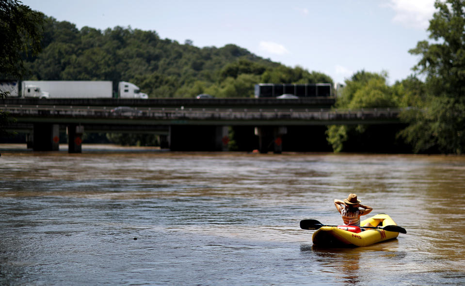 FILE - This June 27, 2018 file photo shows a kayaker floating down the Chattahoochee River as traffic spans Interstate 285 in Atlanta. The toe-tapping river song that rhymes Chattahoochee with “hoochie coochie” was one of the biggest hits of Alan Jackson’s career, earning him two Country Music Association Awards and two Grammy nominations. (AP Photo/David Goldman, File)