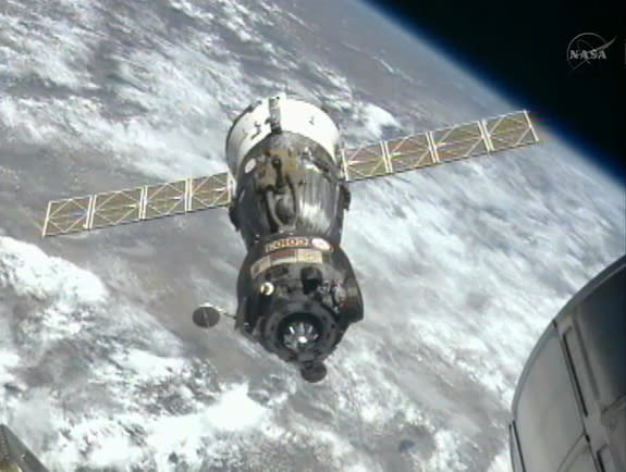 The Russian Soyuz TMA-03M backs away from the International Space Station after undocking to return three members of the Expedition 31 crew to Earth on July 1, 2012, in this still from a NASA broadcast.