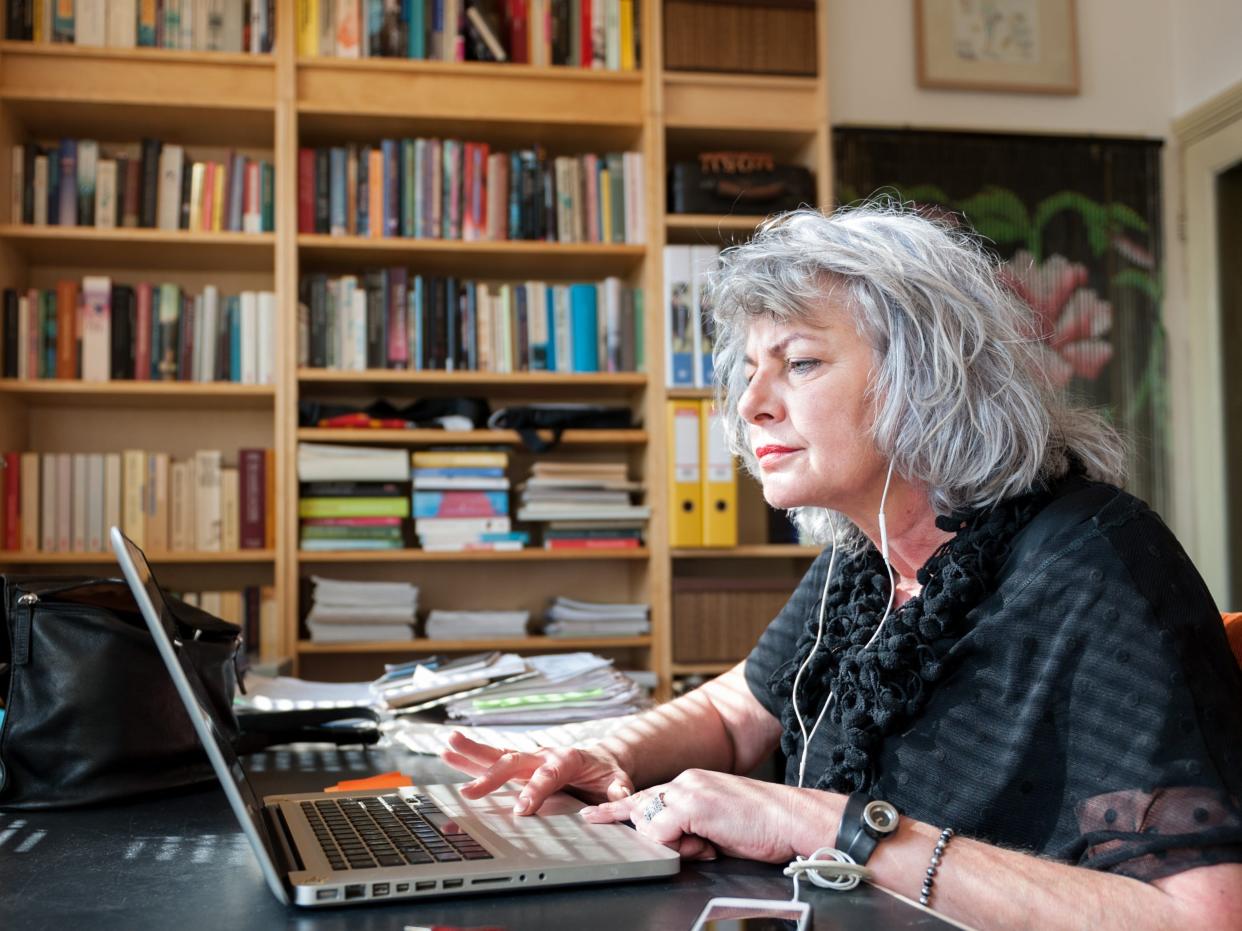 A woman is seen working from home.