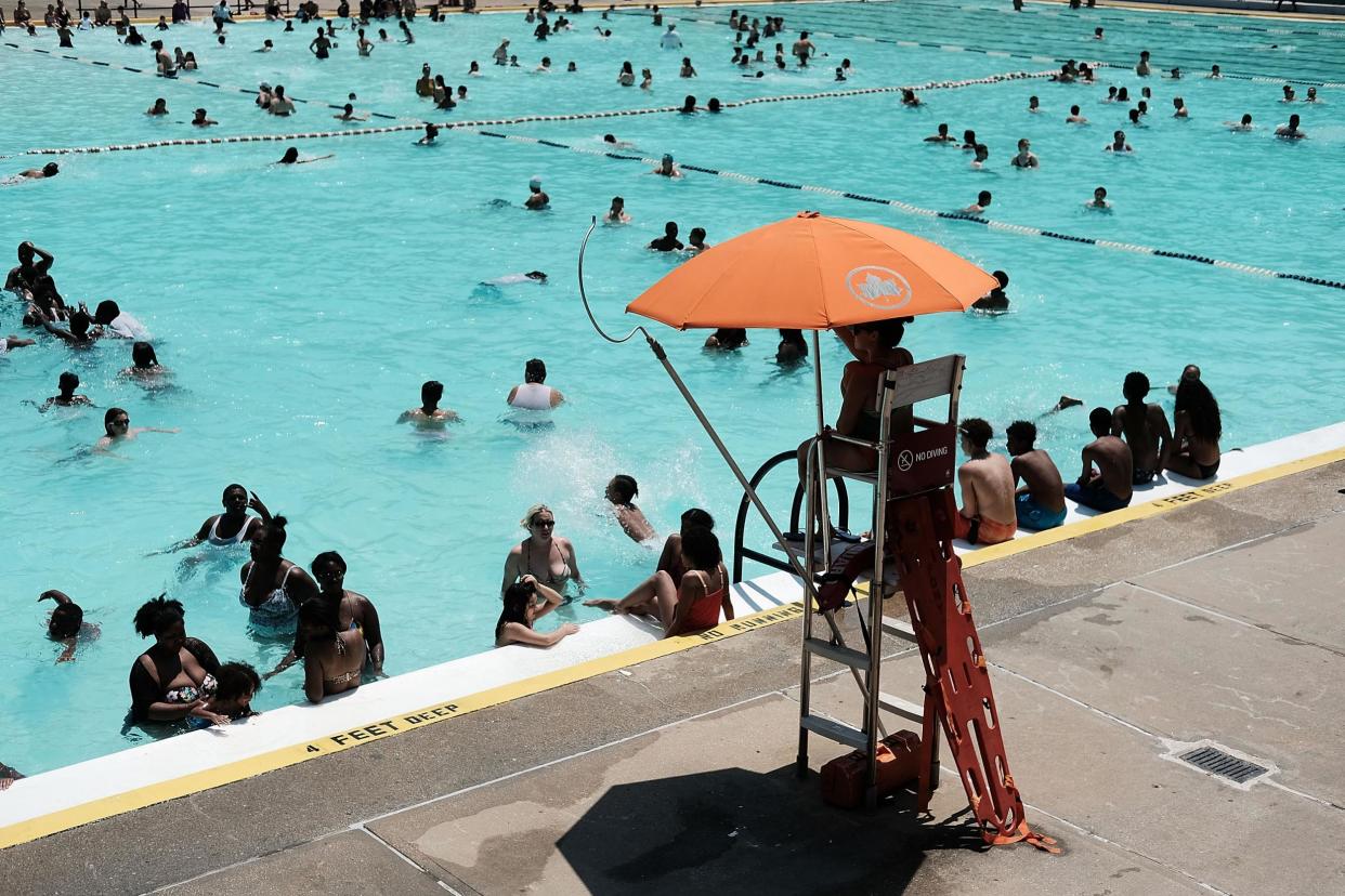 People enjoy a hot afternoon at a different swimming pool in New York City: Spencer Platt/Getty Images