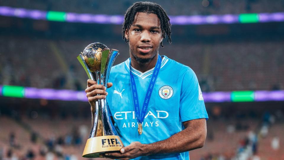 JUST CHAMPION: Micah proudly poses with the FIFA Club World Cup trophy.