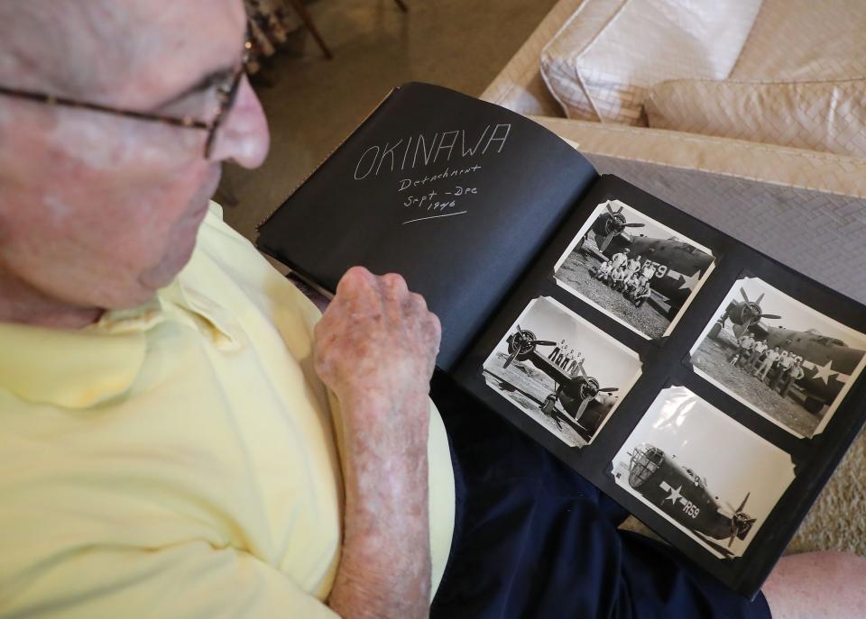 Navy veteran Richard Sirinsky, pictured Dec. 2, looks through some old photos of his time in the U.S. Navy inside his Palm Desert home.