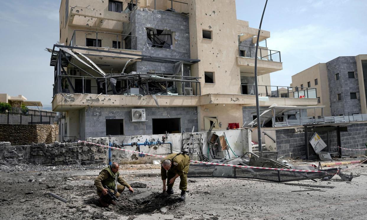 <span>Israeli security forces examine the site of a rocket strike fired from Lebanon, in Kiryat Shmona, northern Israel.</span><span>Photograph: Ariel Schalit/AP</span>