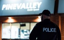 A police officer stands outside the Pine Valley Cafe Sport on Rowntree Dairy Road in Vaughan, one of 11 cafes where police executed warrants in an illegal gaming investigation named Project Sindacato in Vaughan