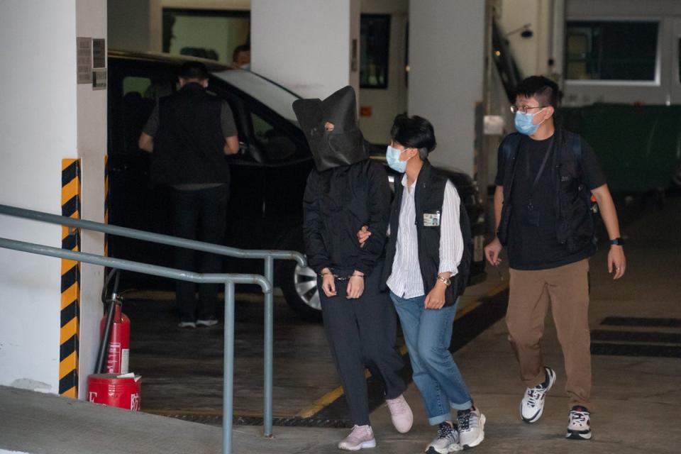 Police officers escort one of the five accused (Getty Images)