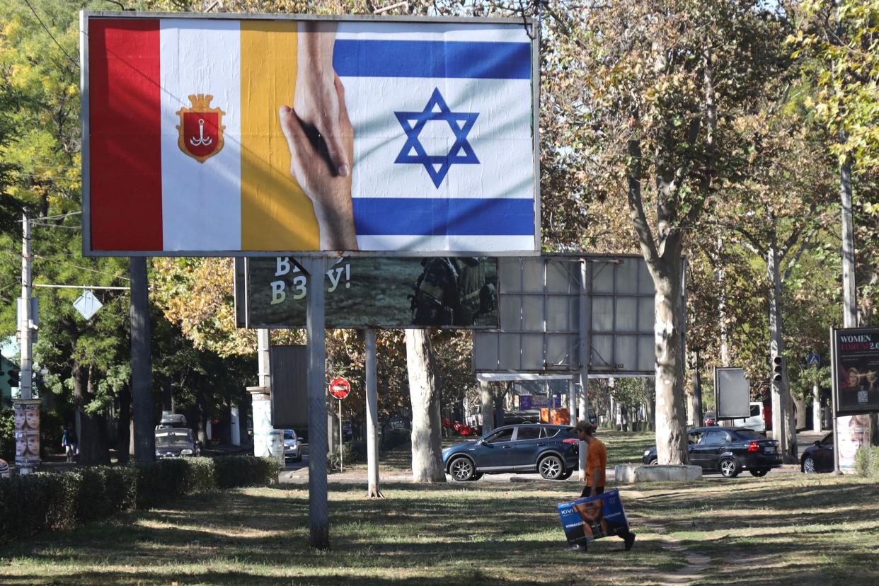 People in Odesa show their support for Israelis with the unveiling of the national flag (AFP via Getty Images)