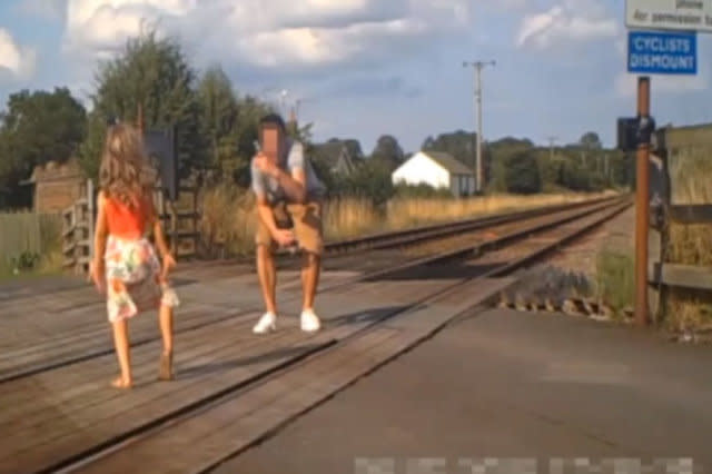 Shocking CCTV footage has been released which shows people risking their lives on level crossings - including a father and his young daughter posing for a photo shoot.