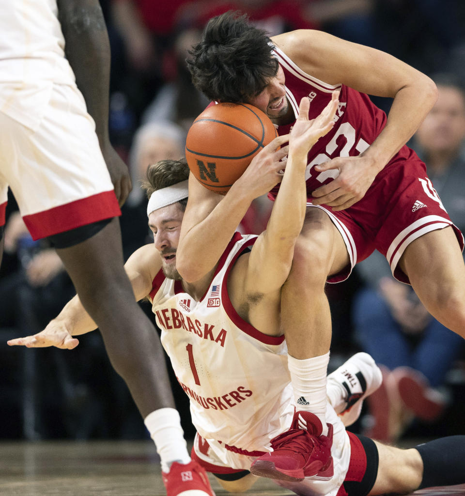 Nebraska's Sam Hoiberg (1) dives for a loose ball against Indiana's Trey Galloway (32) during the second half of an NCAA college basketball game Wednesday, Jan. 3, 2024, in Lincoln, Neb. Nebraska defeated Indiana 86-70. (AP Photo/Rebecca S. Gratz)