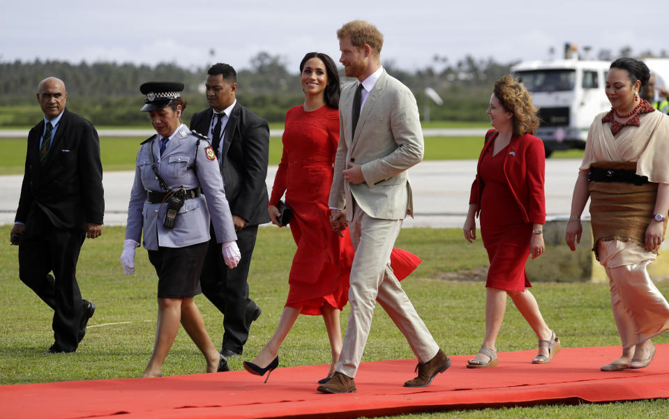 Britain's Prince Harry and Meghan, Duchess of Sussex arrive in Nuku'alofa,Tonga, Thursday, Oct. 25, 2018. Prince Harry and his wife Meghan are on day 10 of their 16-day tour of Australia and the South Pacific. (AP Photo/Kirsty Wigglesworth)