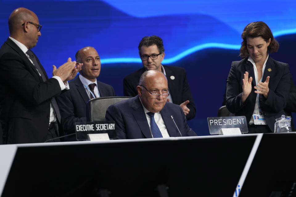 Sameh Shoukry, president of the COP27 climate summit, receives a standing ovation following a speech during the closing plenary session at the U.N. Climate Summit, Sunday, Nov. 20, 2022, in Sharm el-Sheikh, Egypt. (AP Photo/Peter Dejong)