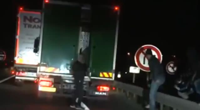 One man opens the door of the truck as it sits in traffic. Photo: YouTube