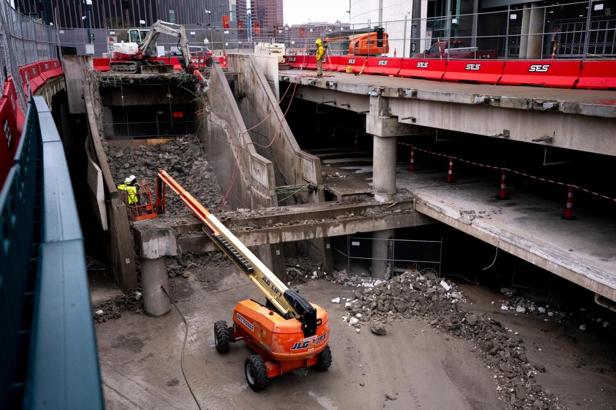 Construction workers demolish a section of Paycor Stadium.