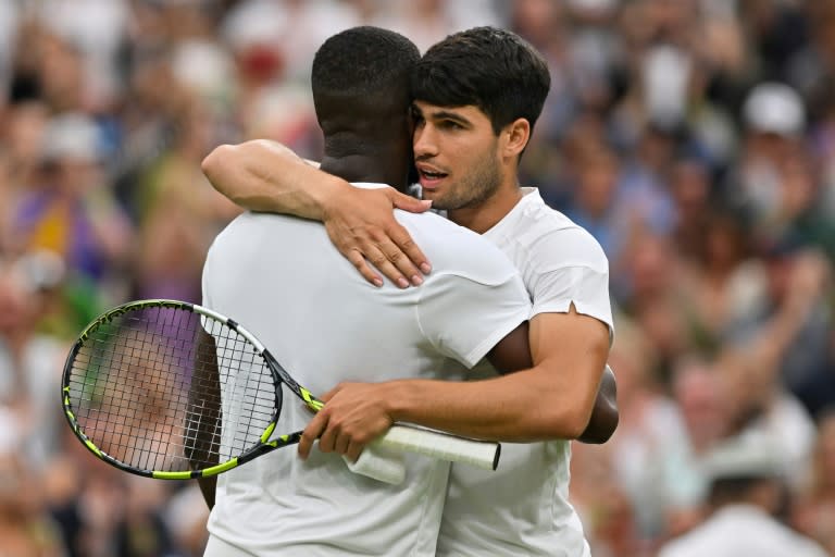 Thriller: Carlos Alcaraz embraces Frances Tiafoe after his five-set win on Friday (Glyn KIRK)