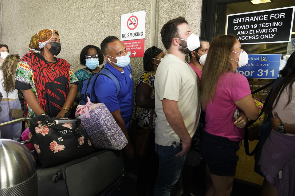 Passengers wait in a long line to get a COVID-19 test to travel overseas at Fort Lauderdale-Hollywood International Airport, Friday, Aug. 6, 2021, in Fort Lauderdale, Fla. Recent flight cancelations caused many passengers to redo their tests while others were unable to get the test locally due to long lines caused by the surge of the Delta variant. (AP Photo/Marta Lavandier)