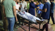 The body of Ibris Khan, 28, who went missing on April 10 during violence in Khargone and found a week later, is carried on a stretcher outside a mortuary in Indore, the central Indian state of Madhya Pradesh, Monday, April 18, 2022. On April 10, a Hindu festival marking the birth anniversary of Lord Ram turned violent in Madhya Pradesh state’s Khargone city after Hindu mobs marched past Muslim neighborhoods and mosques. Videos showed hundreds of them dancing and cheering in unison to songs blared from loudspeakers that included calls for violence against Muslims. (AP Photo/Kashif Kakvi)