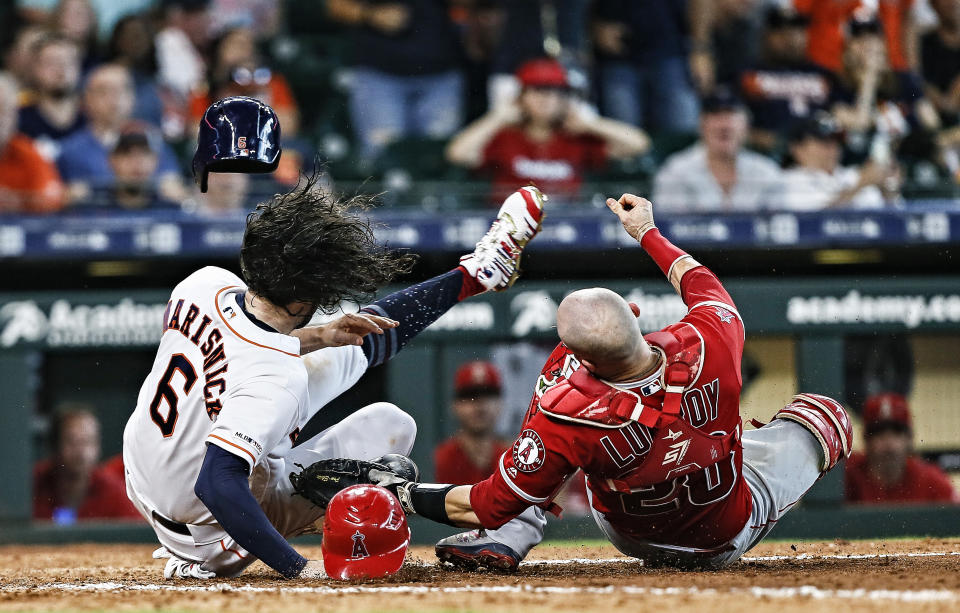 HOUSTON, TEXAS - JULY 07: Jake Marisnick #6 of the Houston Astros collides with catcher Jonathan Lucroy #20 of the Los Angeles Angels of Anaheim as he attempts to score in the eighth inning at Minute Maid Park on July 07, 2019 in Houston, Texas.  Marisnick was called out under the home plate collision rule. (Photo by Bob Levey/Getty Images)
