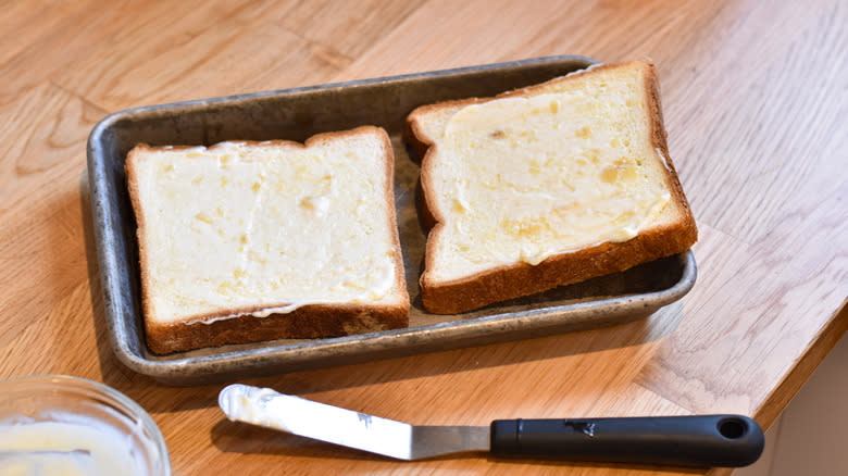 spreading mayonnaise on bread slices