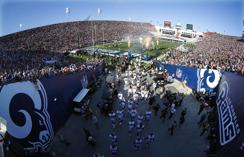 FILE - In this Aug. 13, 2016, file photo, the Los Angeles Rams take the field at Los Angeles Memorial Coliseum for a preseason NFL football game against the Dallas Cowboys, in Los Angeles. Opened in 1923, the Coliseum first gained the Rams as a tenant in 1946 when they moved west from Cleveland. (AP Photo/Ryan Kang, File)