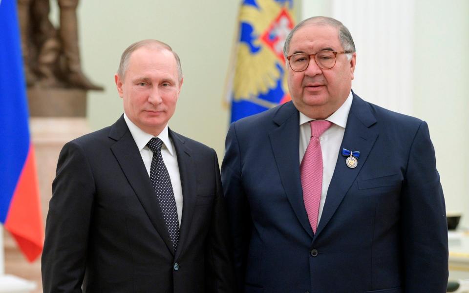 Alisher Usmanov (right) poses with Vladimir Putin at a Kremlin ceremony in 2017