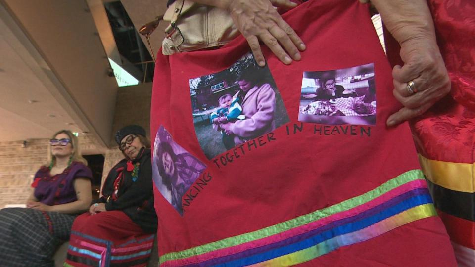 Myrna Abraham shows a skirt with photos of her sister Sharon.  