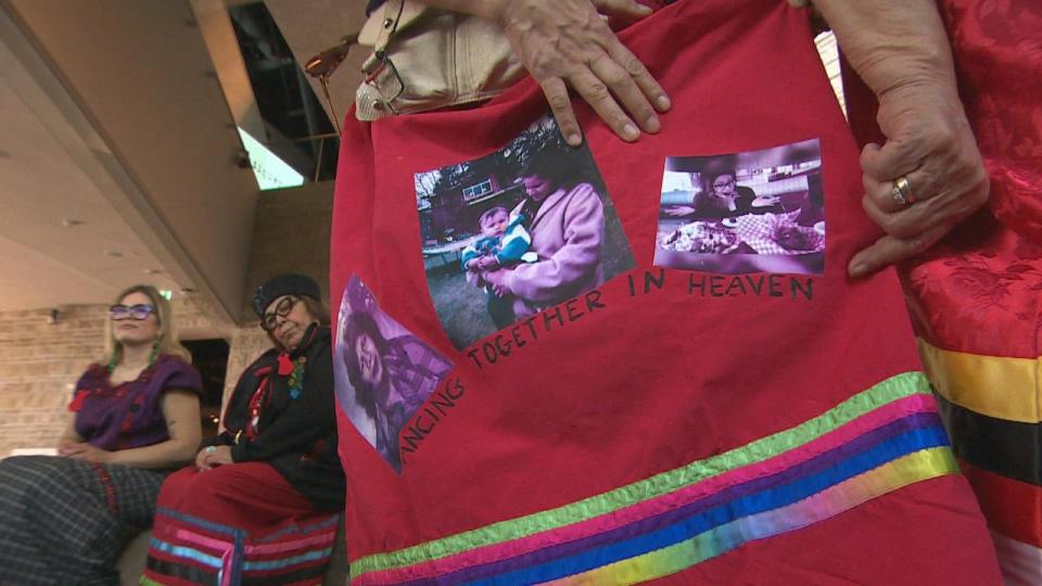 Myrna Abraham shows a skirt with photos of her sister Sharon.